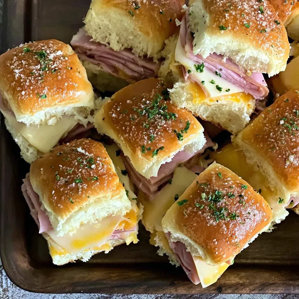 A tray of ham and cheese sandwiches.