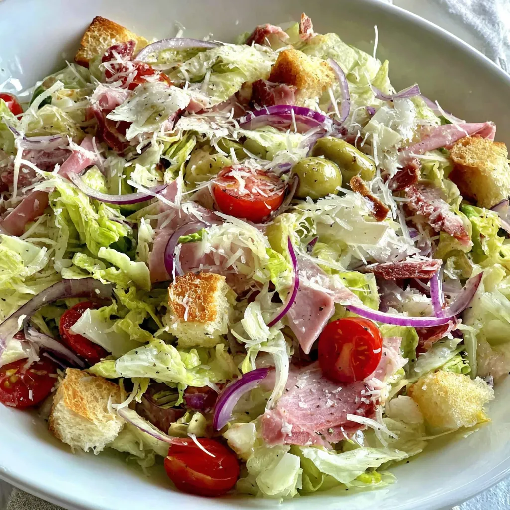 A salad with lettuce, tomatoes, and bread.