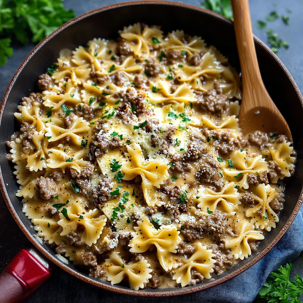 A bowl of creamy Parmesan garlic beef bowtie pasta.