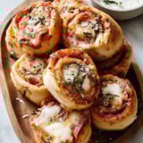 A plate of pepperoni pizza rolls.
