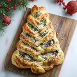 A spinach breadsticks shaped like a christmas tree.