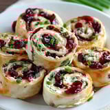 A plate of cranberry feta pinwheels.
