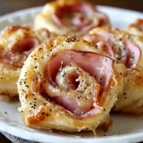 Hot ham cheese pinwheels on a plate.