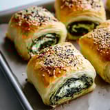 A tray of savory pastry rolls.