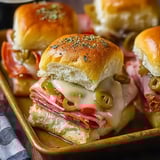 A platter of sandwiches with meat and cheese.