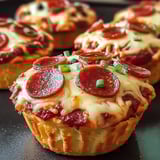 A close up of a deep dish pizza cupcake.
