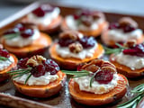 Sweet potato rounds with white cheese and cranberries.