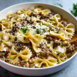 A bowl of creamy Parmesan garlic beef bowtie pasta.