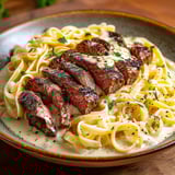 A bowl of pasta with meat and cheese.