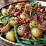 A plate of green beans and potatoes.