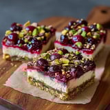 Three pieces of cherry pistachio cheesecake bars.